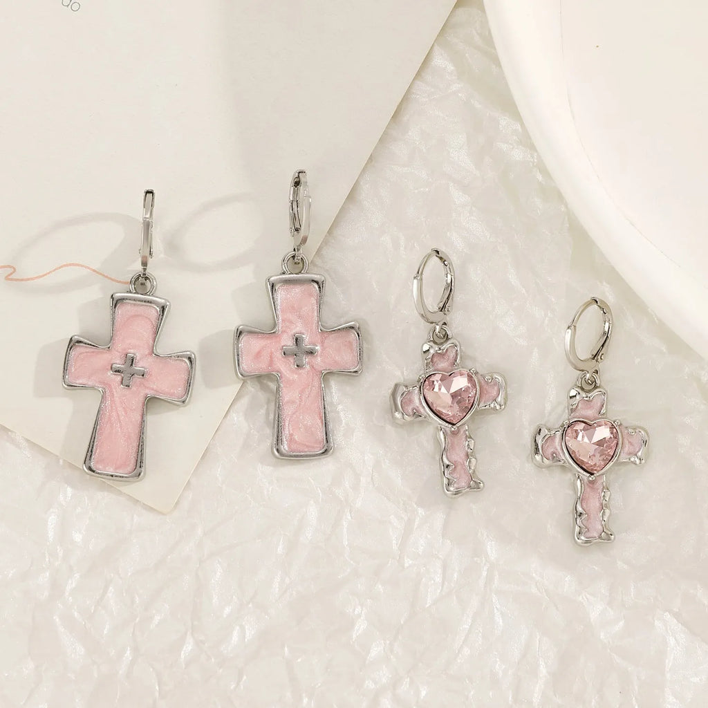 Women's alloy earrings with cross and heart designs in white, black, and silver colour options.