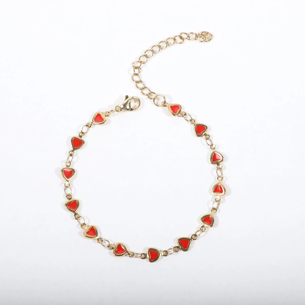 Stainless steel heart-shaped bracelet with 18K gold plating on an adjustable link strap.