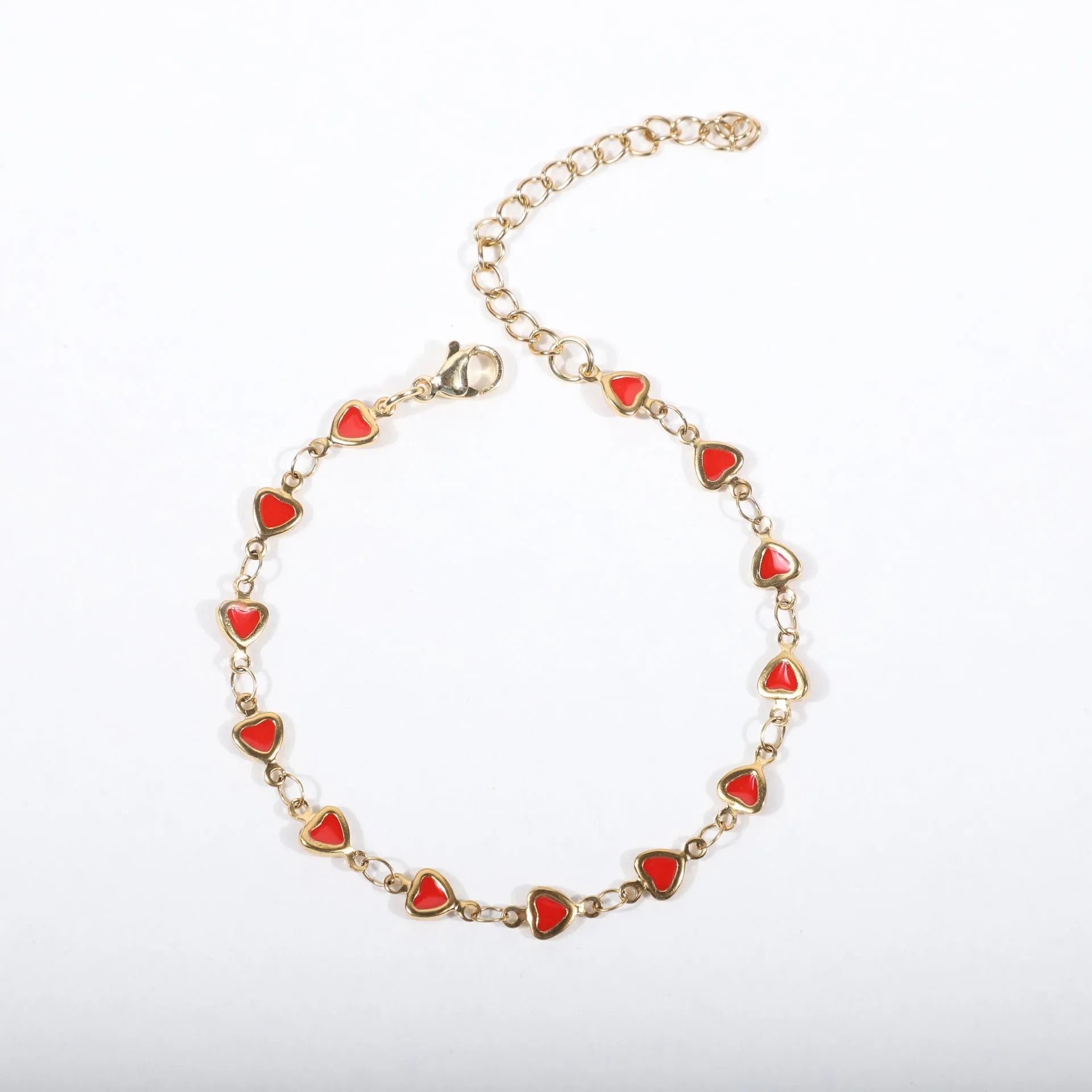 Stainless steel heart-shaped bracelet with 18K gold plating on an adjustable link strap.