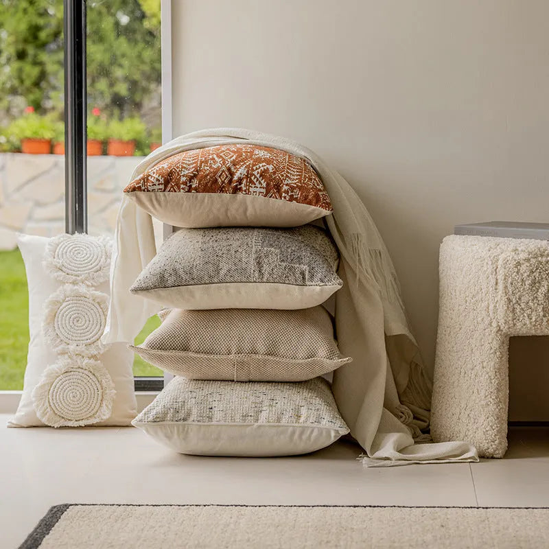 Solid colour decorative cushion on a grey sofa, showing red coffee brown and plain colour options.
