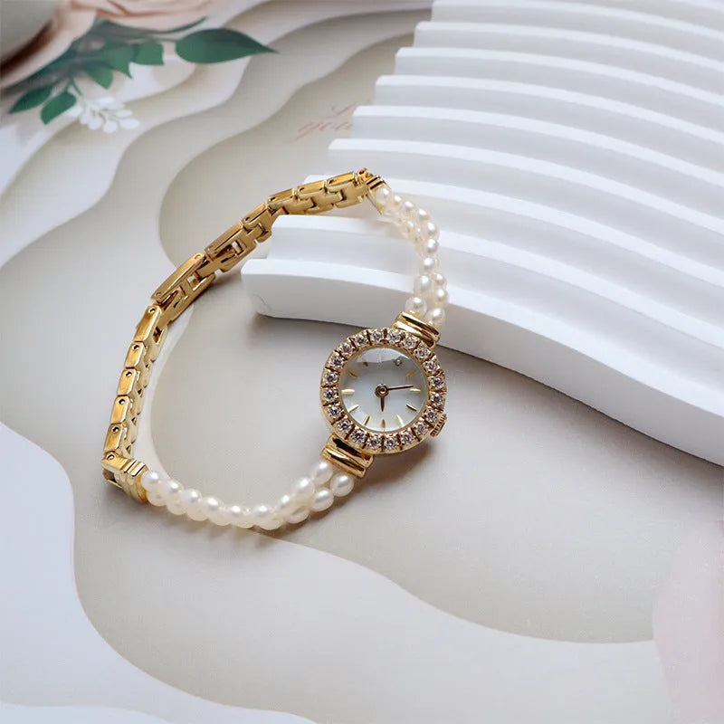Women's light gold bracelet watch with freshwater pearls and round 18mm dial