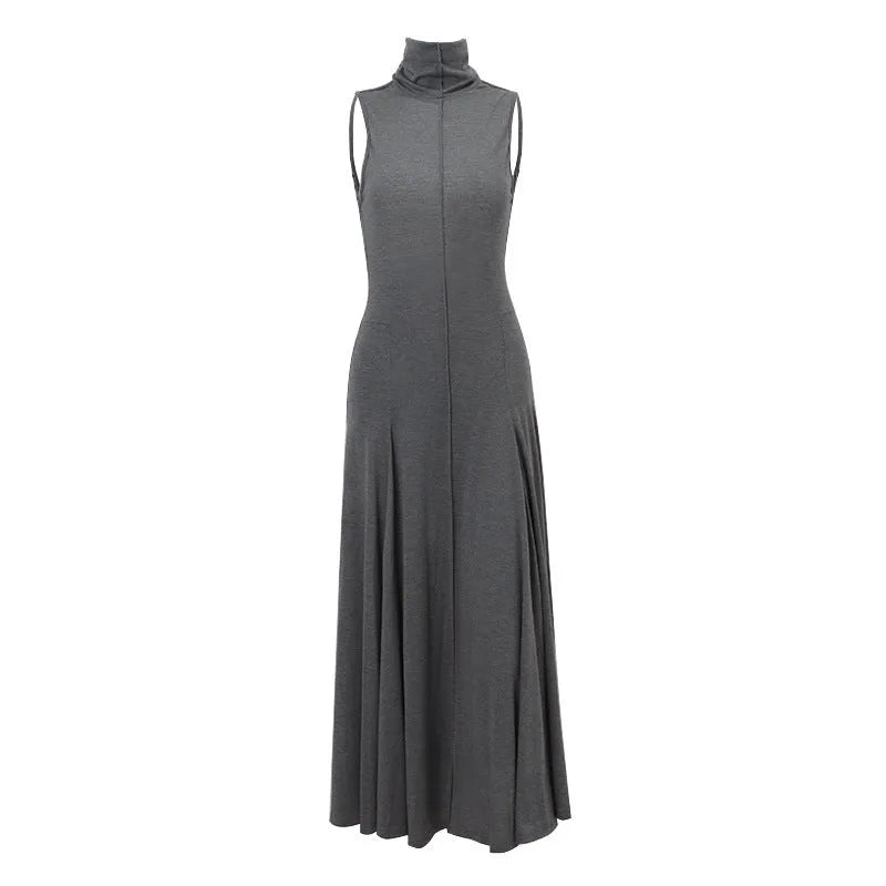 Grey slim-fit half turtleneck backless dress on a woman, showing sleeveless and high-waisted design.