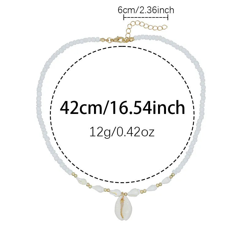 White shell bead necklace with conch pendant and mother-of-pearl detail
