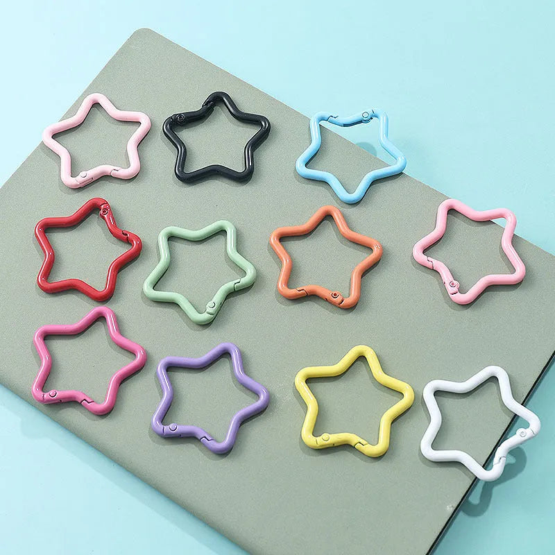 Zinc alloy five-pointed star keychain charm in assorted colours on a key ring.
