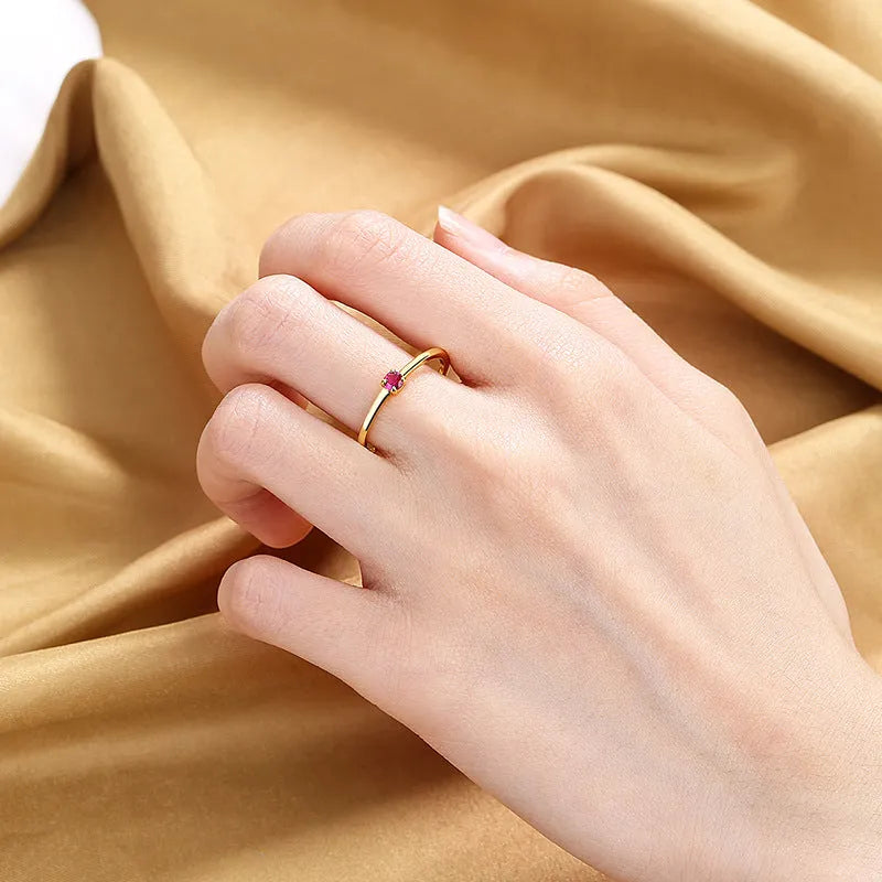 Simple geometric copper ring with a single round diamond, shown in blue, green, red, and white colour options.