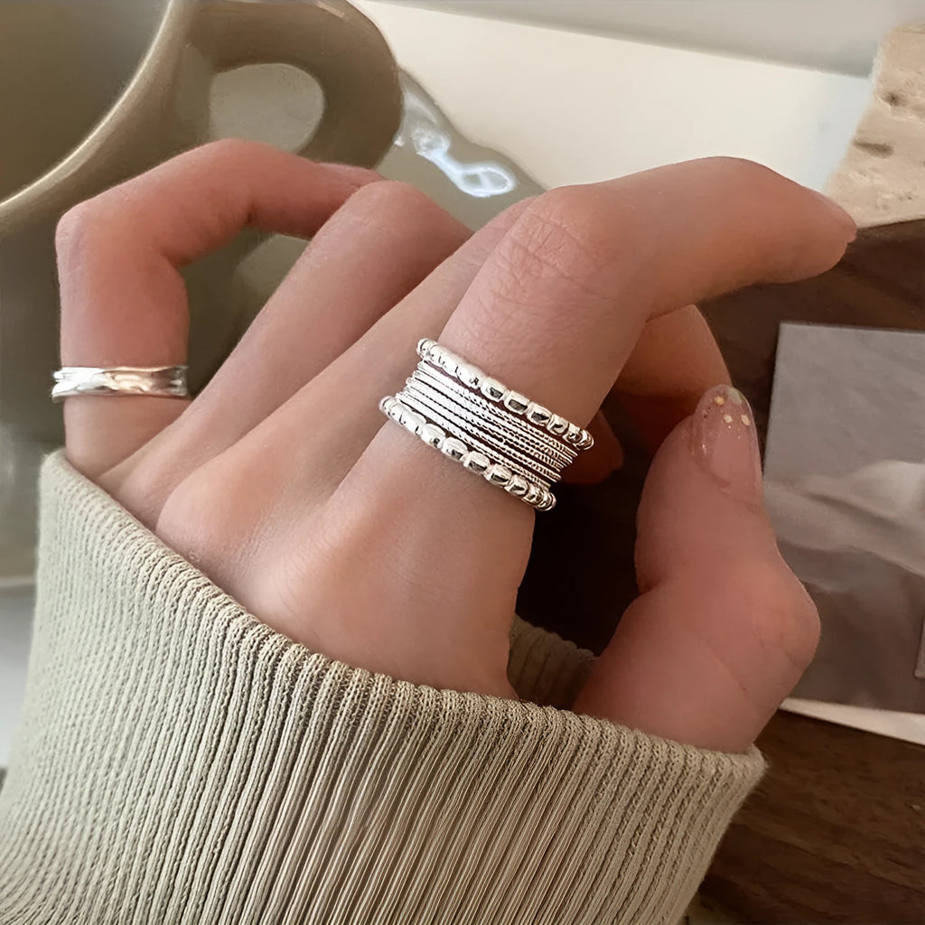 Adjustable opening copper alloy ring with geometric shape and woven twisted multilayer design