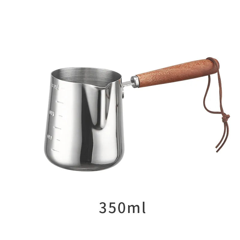 Stainless steel coffee cup with wooden handle showing measurement scale marks
