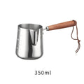 Stainless steel coffee cup with wooden handle showing measurement scale marks