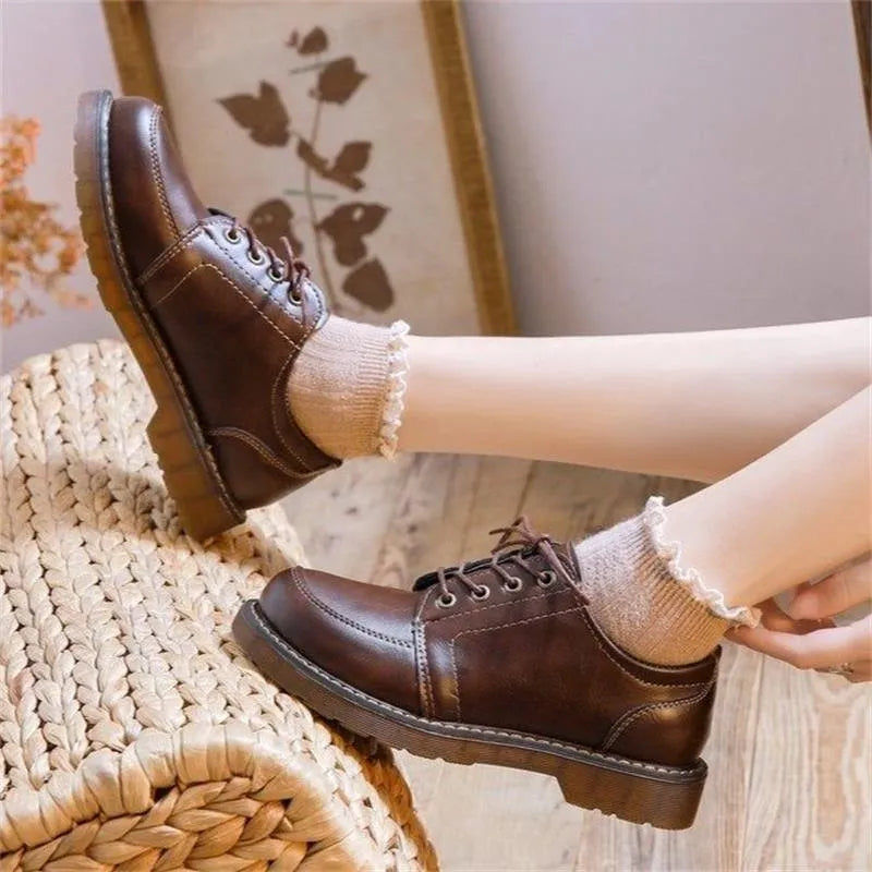 Women's black preppy retro Mary Jane pumps with low square heel and front lace-up.