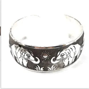 Open carved alloy bracelet with ethnic Miao-inspired patterns in adjustable design