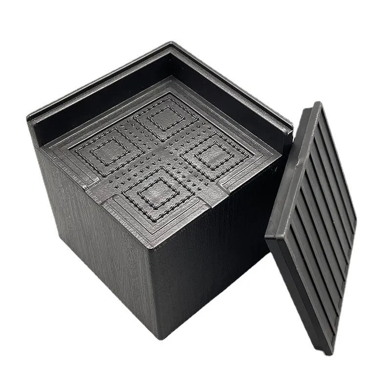Four black plastic bed foot risers for furniture height adjustment