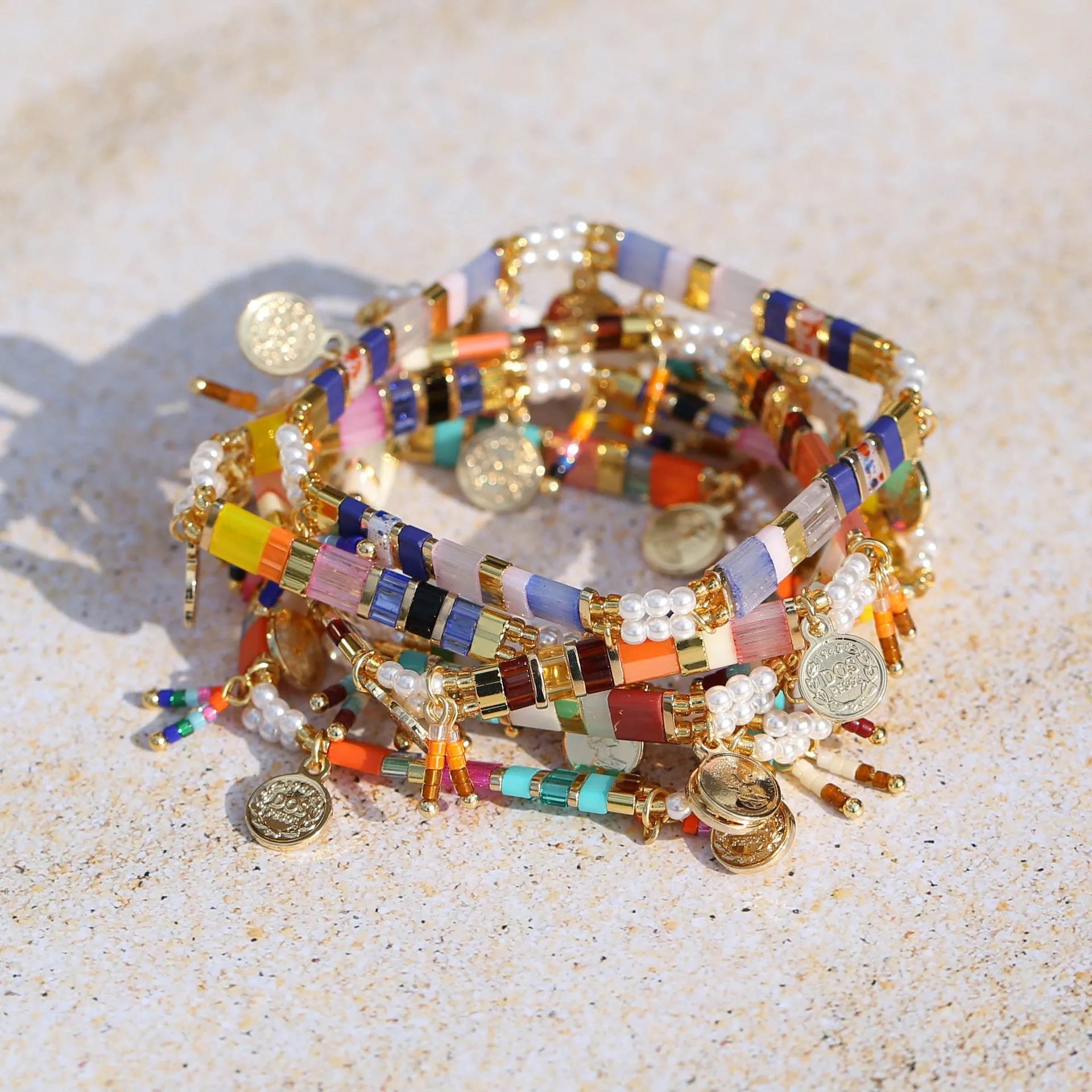 Women's handcrafted imitation pearl bracelet shown in one of six available colour variations.