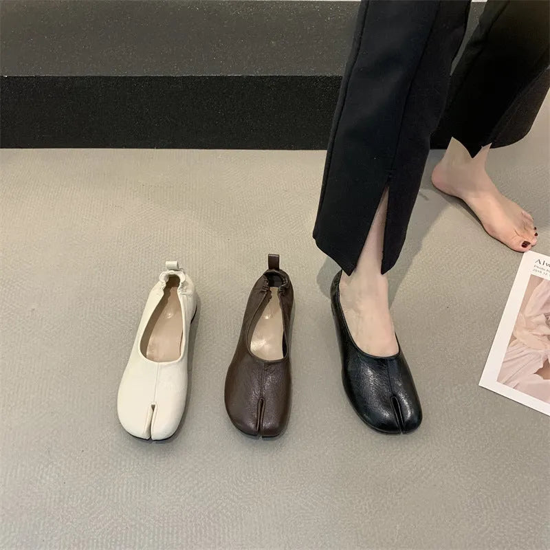 Women's black split toe chunky heel pumps with round head and rubber sole on a white background.