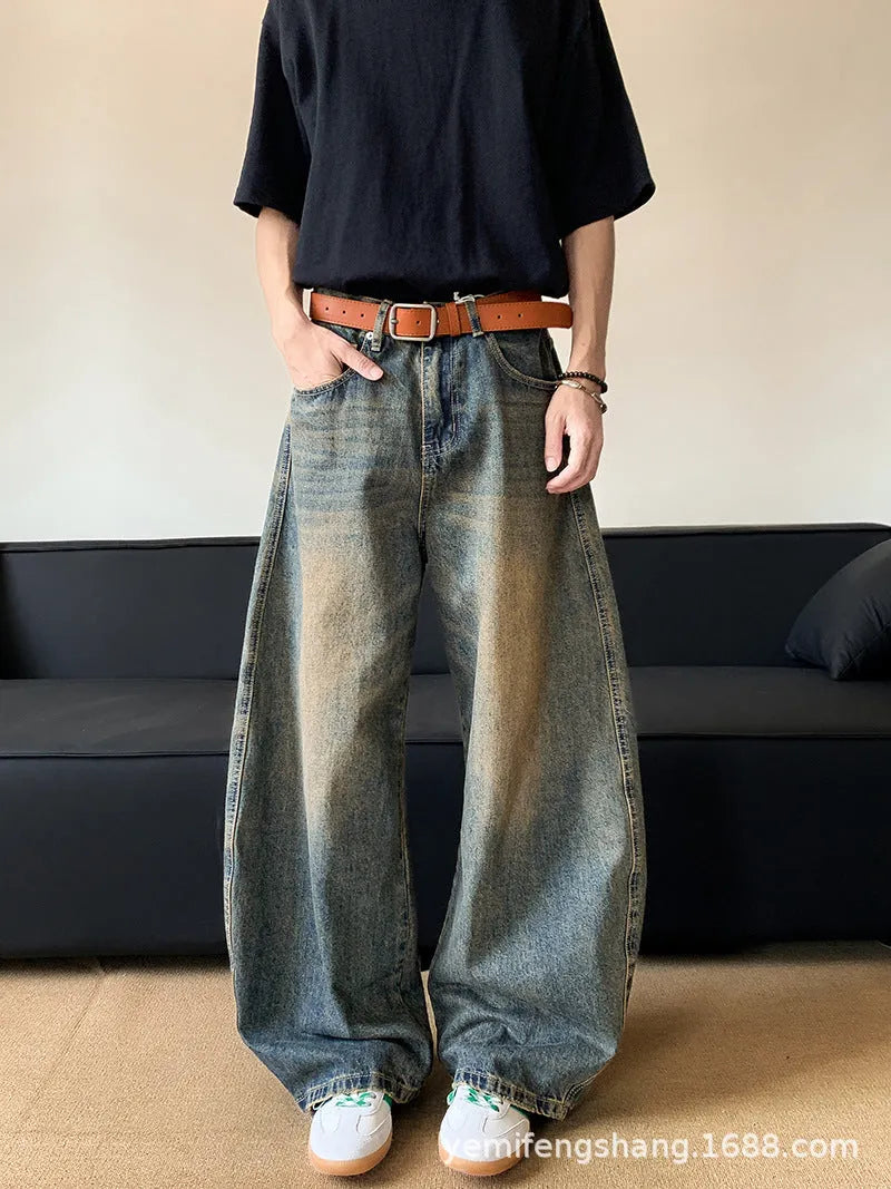 Men's distressed retro blue denim trousers with wide-leg silhouette and micro-elastic cotton-blend fabric