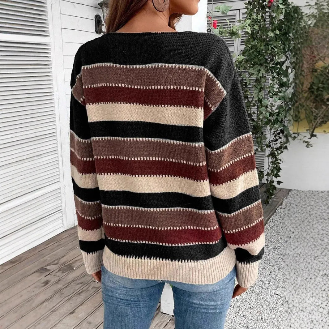 Women's black, blue, and grey colourblock striped polyester pullover sweater on a hanger.