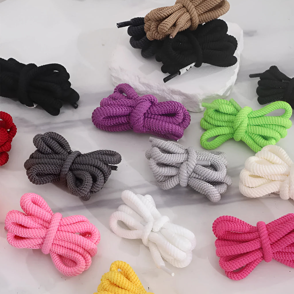 Round oval rope shoelaces in multiple colours including black, pink, blue, and red, shown in different lengths.