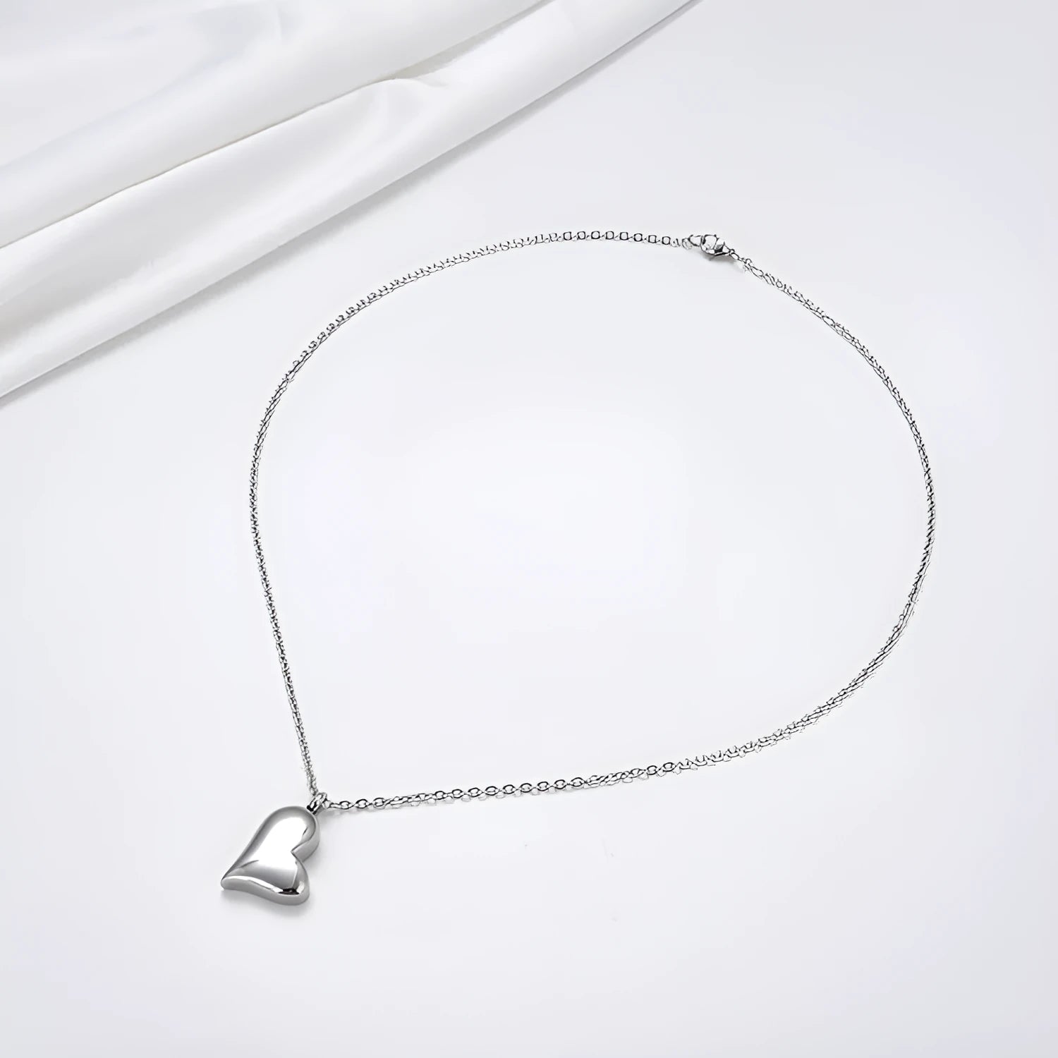 Silver curved peach heart pendant necklace on stainless steel chain with extension