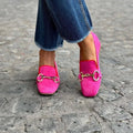 Green suede women's loafers with a round toe, metal buckle fastener, and flat rubber sole.
