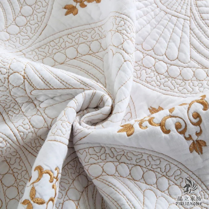 European style embroidered pure cotton bed cover set with two pillowcases on a bed