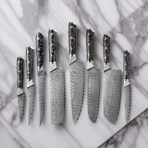 Damascus steel kitchen knife set with eight blades including Japanese and boning knives on a wooden surface