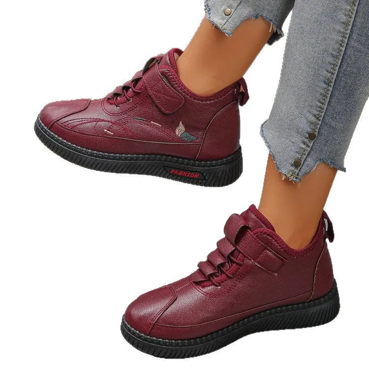 Women's black and red velvet cotton shoes with a hollow-out design and non-slip rubber sole.