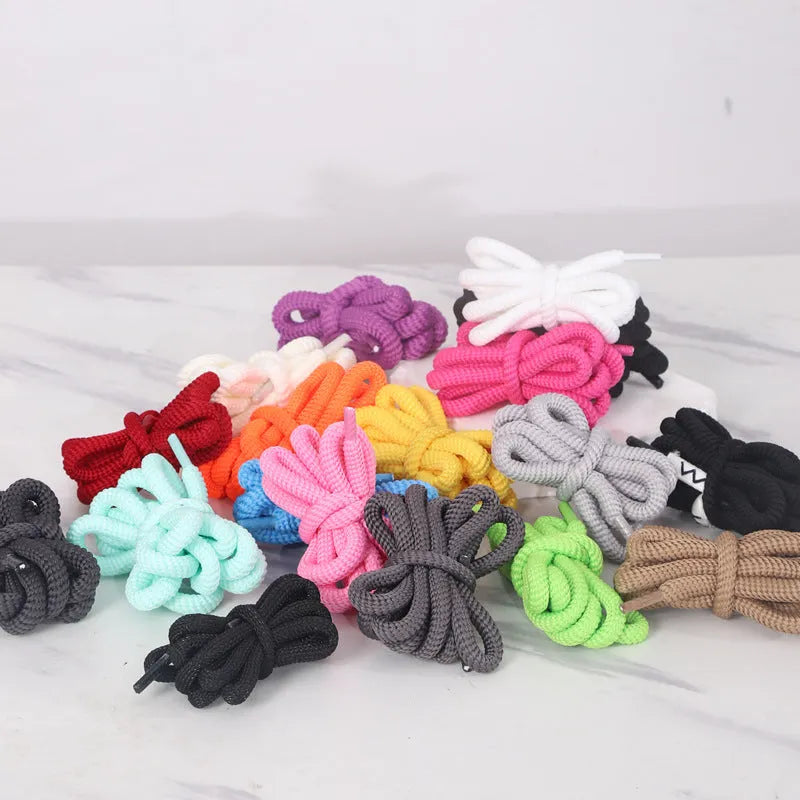 Round oval rope shoelaces in multiple colours including black, pink, blue, and red, shown in different lengths.