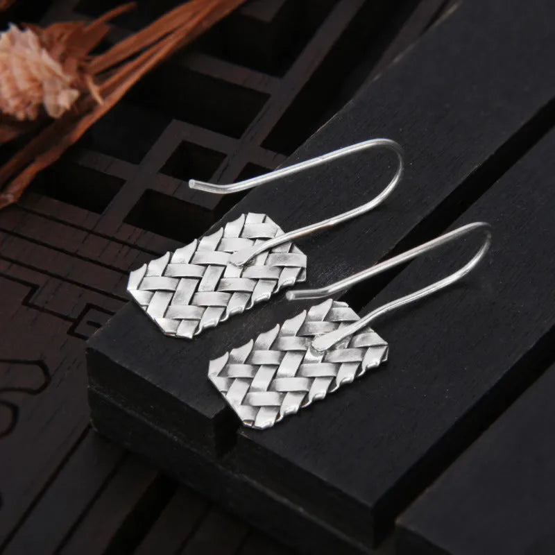 Silver geometric earrings with woven diamond plaid pattern measuring 17.5mm by 11mm