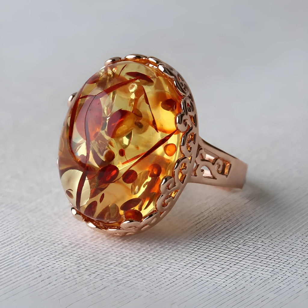 Close-up of a natural amber stone set in a gold-coloured ethnic-style ring band.