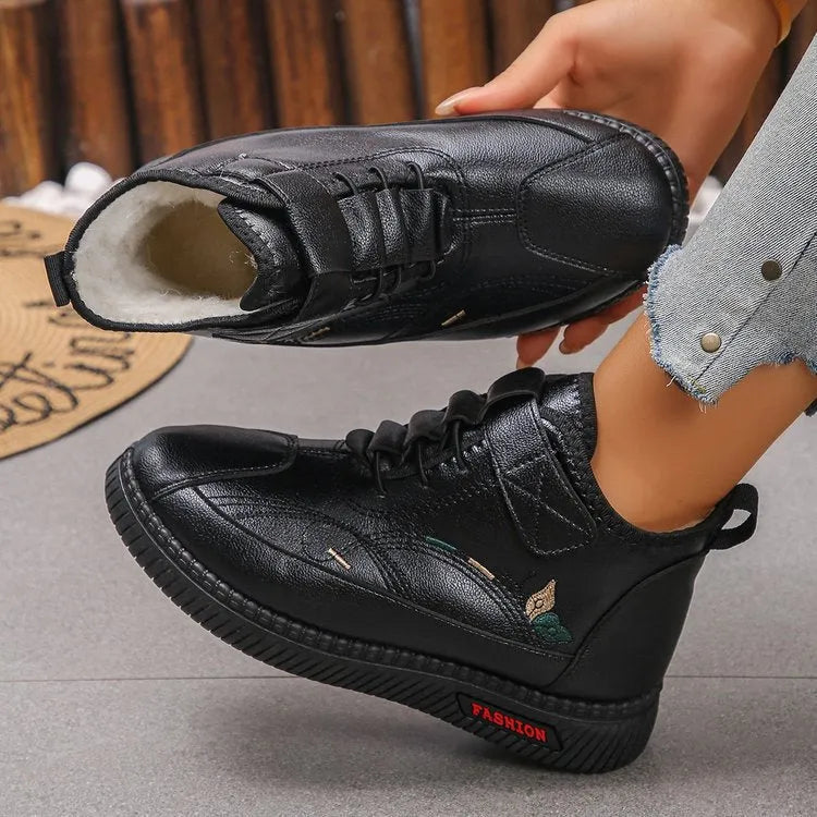 Women's black and red velvet cotton shoes with a hollow-out design and non-slip rubber sole.