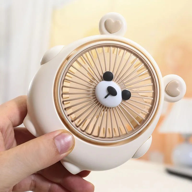 Dog-themed plastic USB desktop fan in Apricot Puppy colour on a wooden desk.
