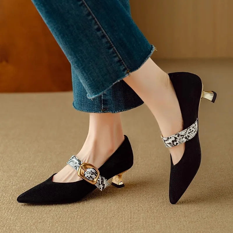 Women's black pointed toe stiletto heels with a buckle fastening and a low-cut design.