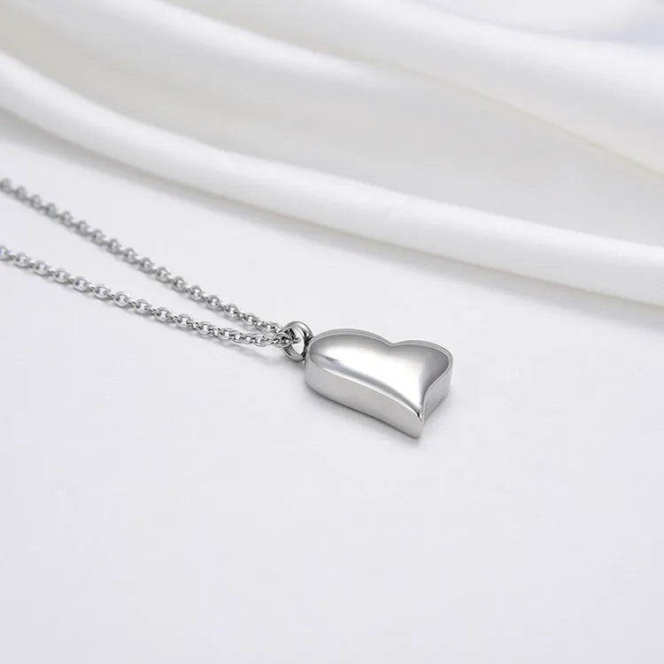 Silver curved peach heart pendant necklace on stainless steel chain with extension