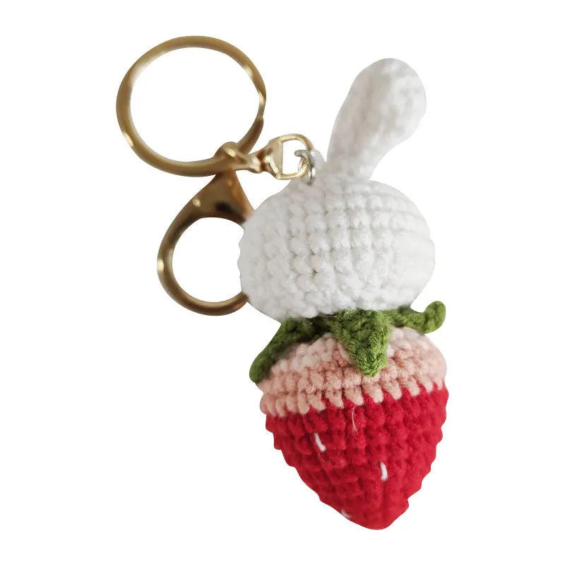 Hand-woven white wire rabbit pendant with strawberry design and key attachment