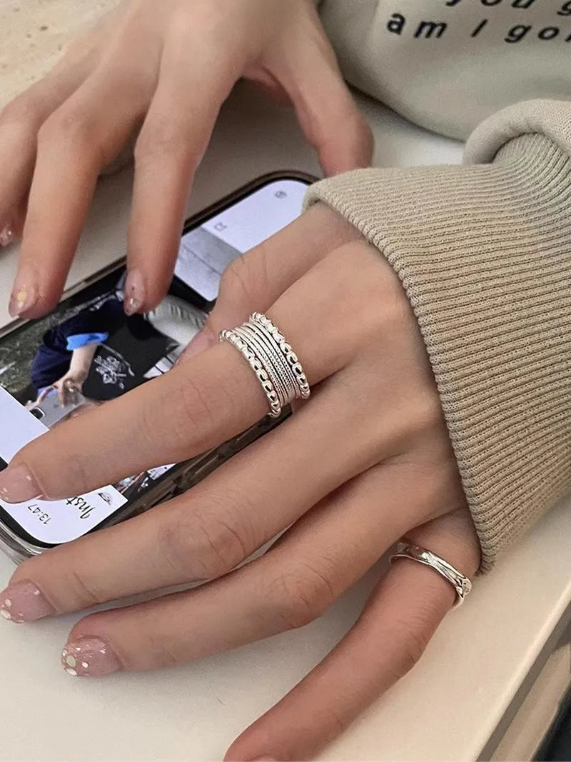 Adjustable opening copper alloy ring with geometric shape and woven twisted multilayer design