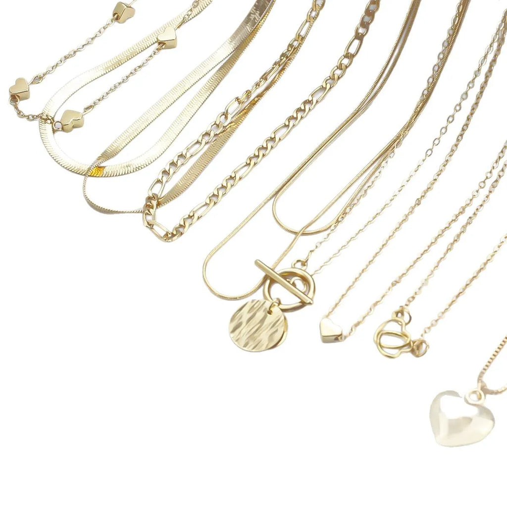10 gold necklaces with snake bone chains and alloy pendants arranged in jewellery set