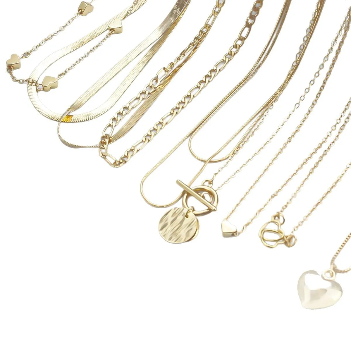 10 gold necklaces with snake bone chains and alloy pendants arranged in jewellery set