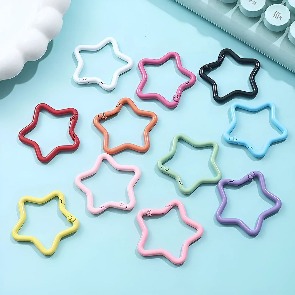 Zinc alloy five-pointed star keychain charm in assorted colours on a key ring.