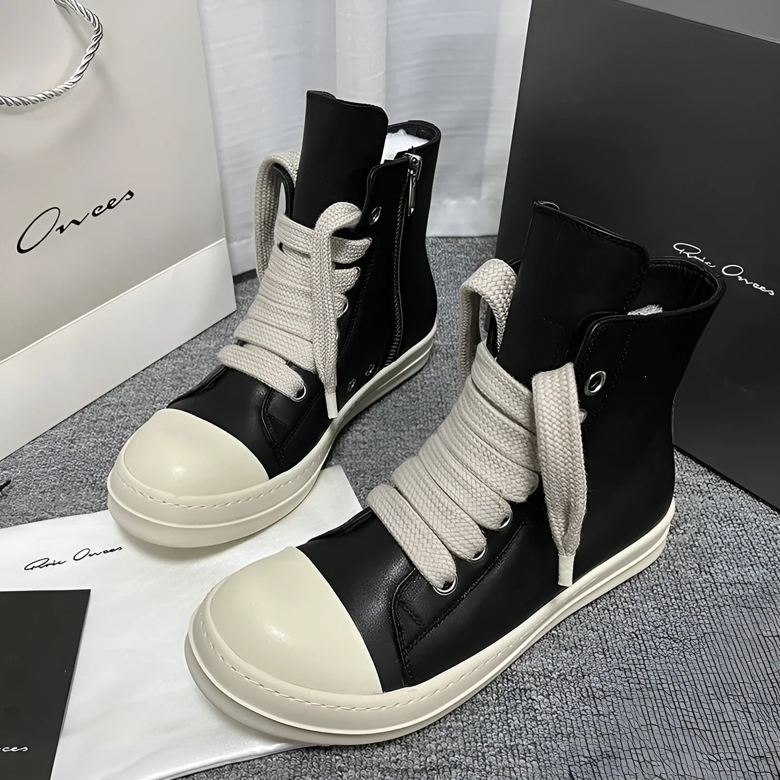 Black genuine cowhide leather high-top sneakers with a side zipper and platform sole.