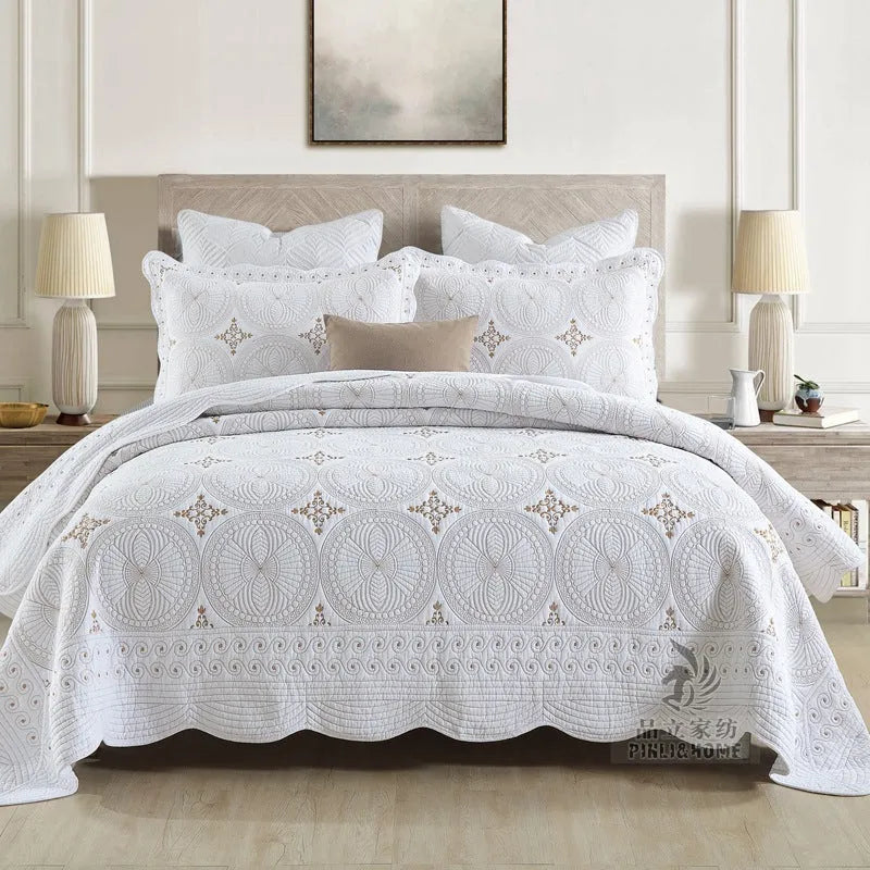 European style embroidered pure cotton bed cover set with two pillowcases on a bed