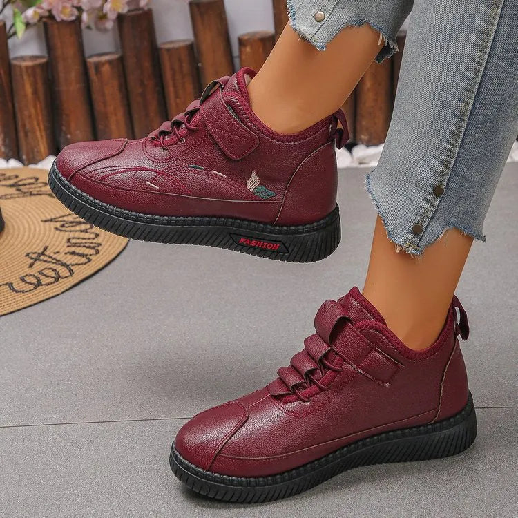 Women's black and red velvet cotton shoes with a hollow-out design and non-slip rubber sole.