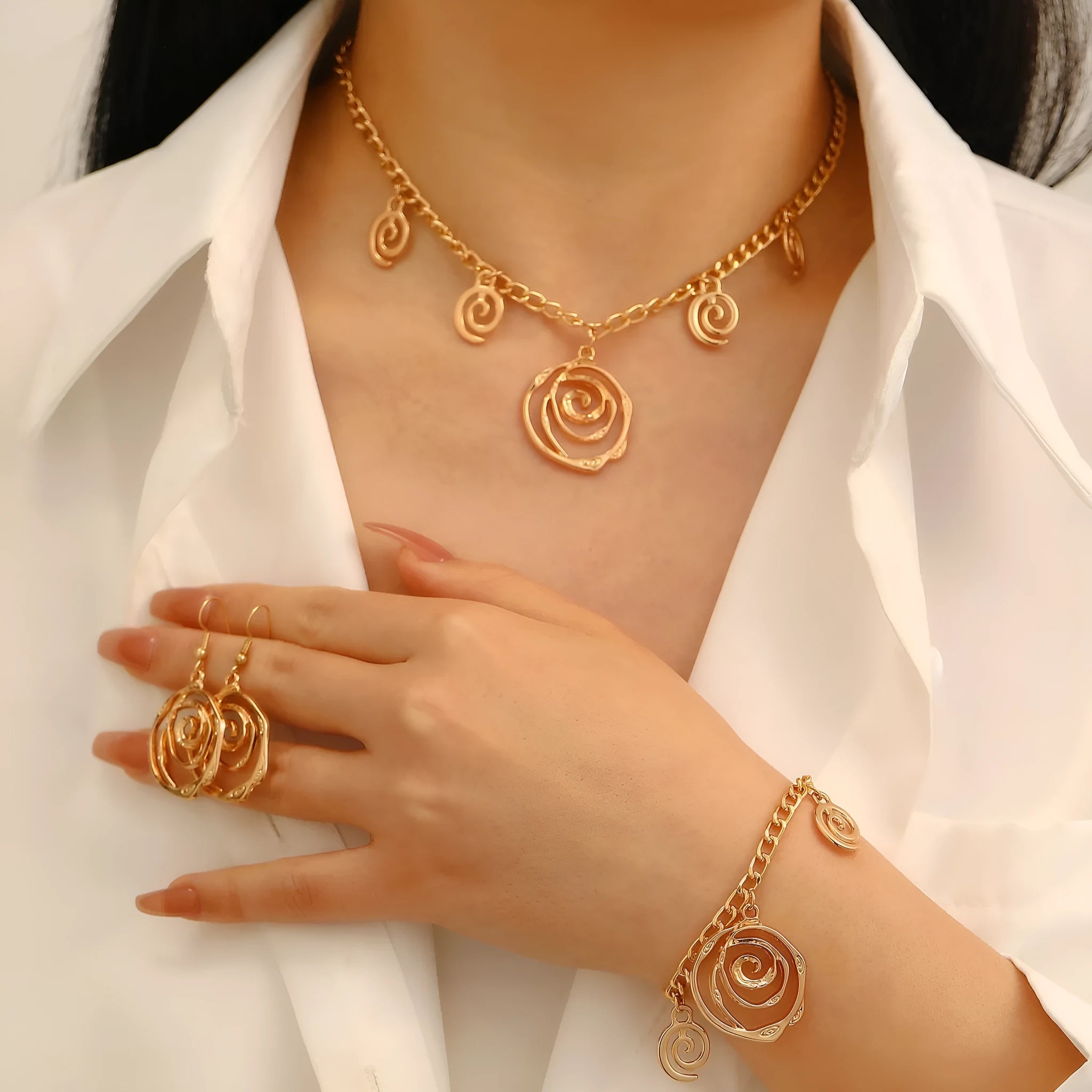Spiral donut jewellery set with necklace, bracelet and earrings showing geometric circle designs in gold and silver finishes