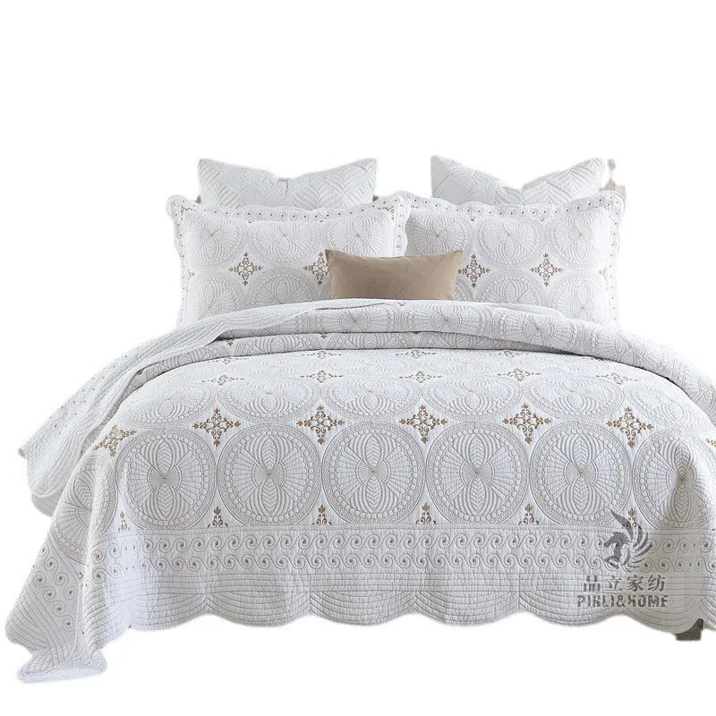European style embroidered pure cotton bed cover set with two pillowcases on a bed