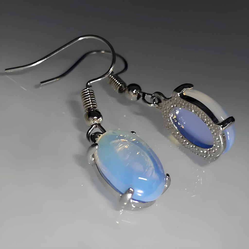 Women's opal earrings with drop shape design in moonlight white colour featuring cross element