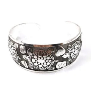 Open carved alloy bracelet with ethnic Miao-inspired patterns in adjustable design