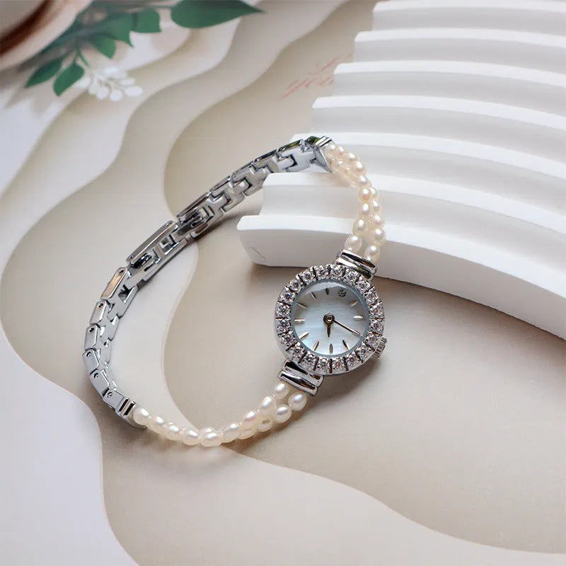 Women's light gold bracelet watch with freshwater pearls and round 18mm dial
