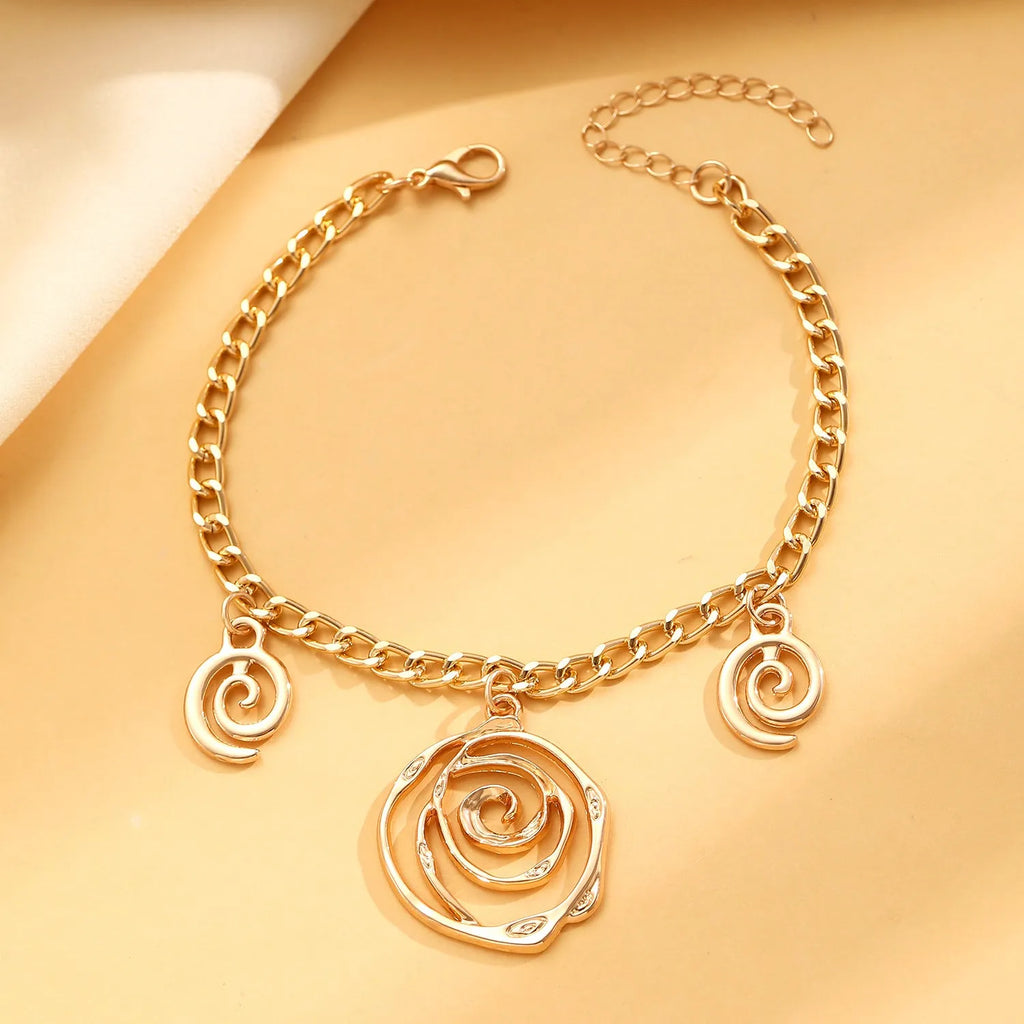 Spiral donut jewellery set with necklace, bracelet and earrings showing geometric circle designs in gold and silver finishes