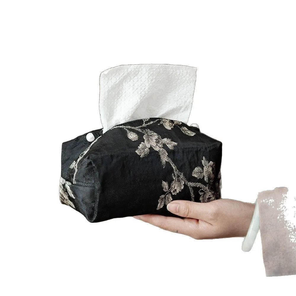 Chinese brocade fabric tissue box cover with embroidered white plum pattern, shown with and without a pearl buckle clasp