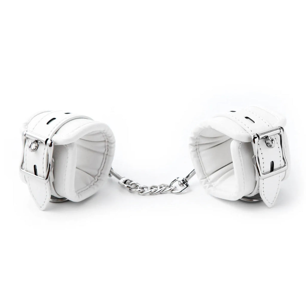White PU sponge bondage set showing handcuffs, footcuffs and neck scarf components