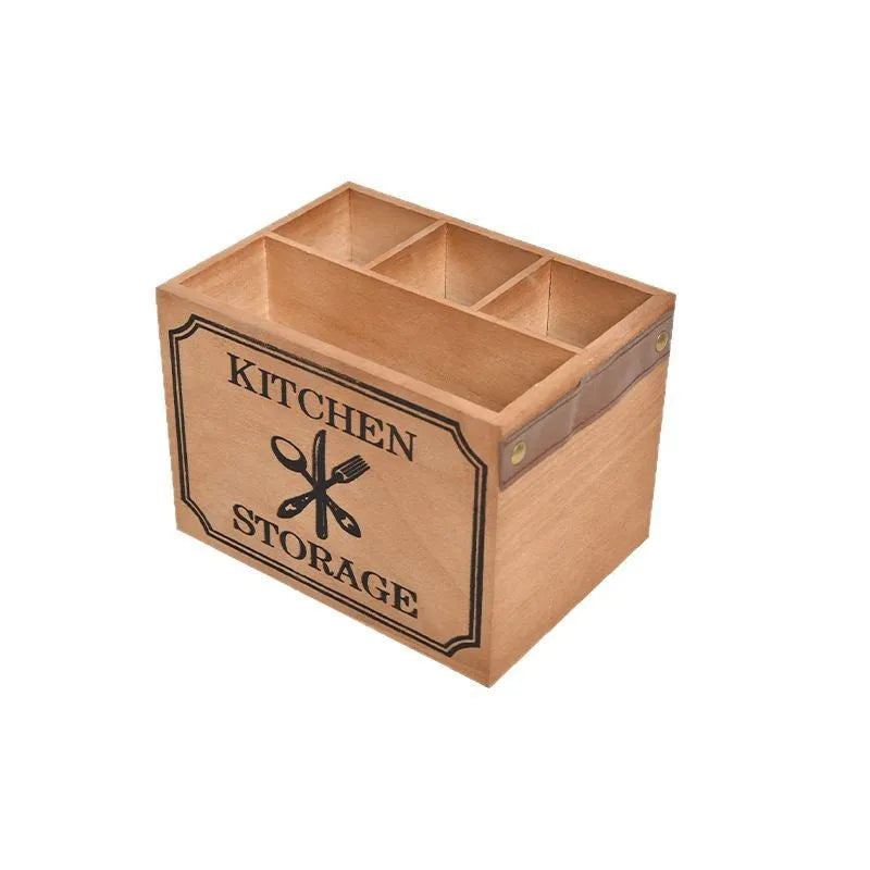 Open-top wooden kitchen storage box with internal grid divider for organising utensils.