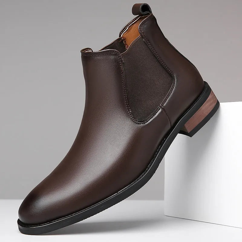 Men's black Chelsea boots with pointed toe design and decorative stitching